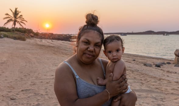 Family on beach at sunset